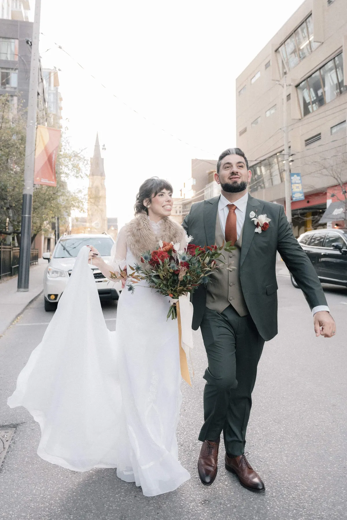 Bride and groom walking through downtown Toronto